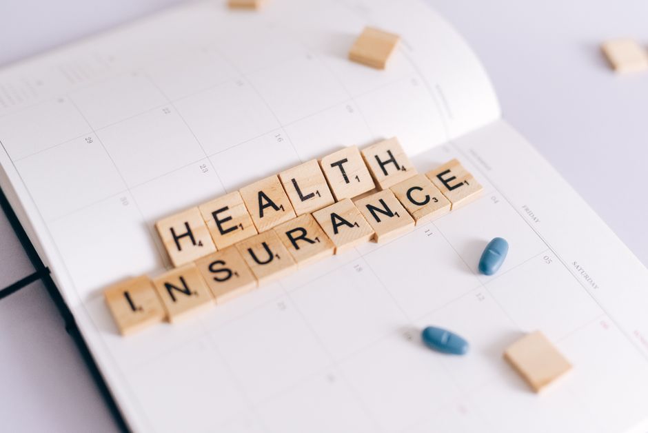 self-employed person comparing health insurance plans on a laptop