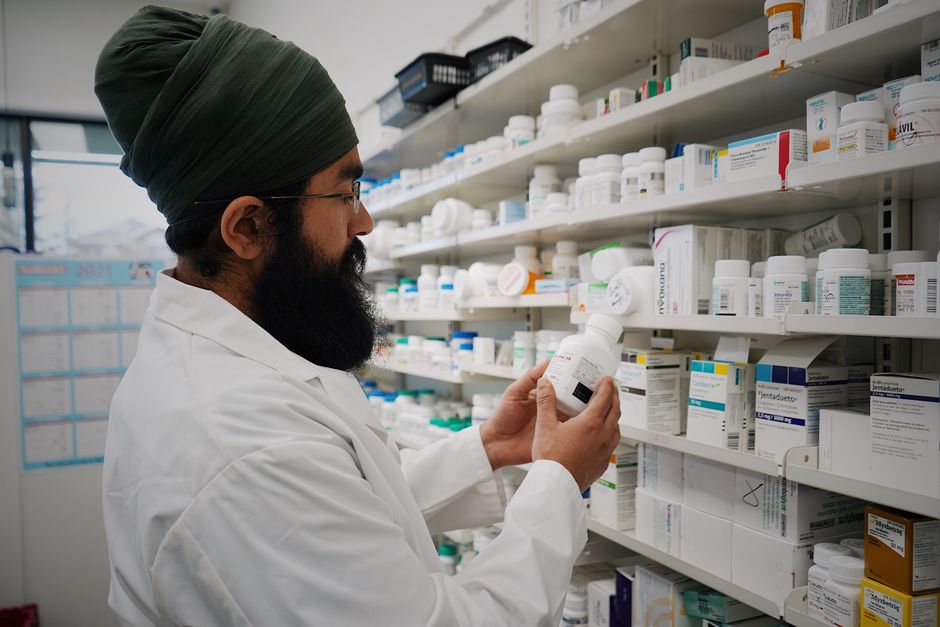 prescription medicine bottles beside a Medicare Part D plan document