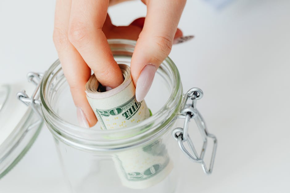 glass jar with coins labeled emergency fund